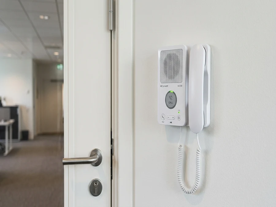 Wireless intercom handset unit used to release a buzzer entry door from a front desk