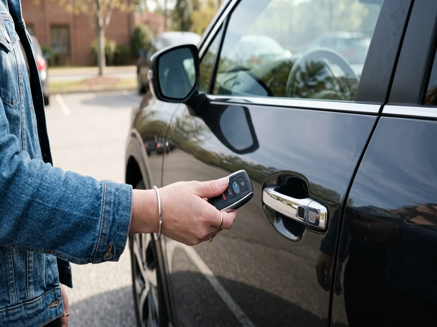 Car proximity push-to-start key fob held near a car door