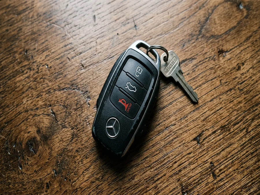 Standalone car key fob remote on a wooden table