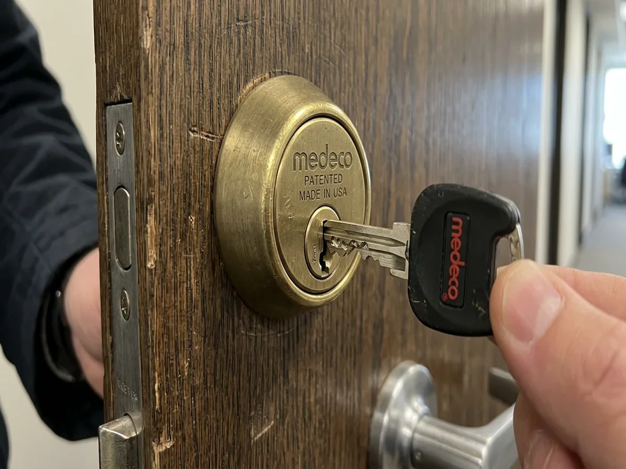 High-security deadbolt with complex patented keyway installed on a commercial door