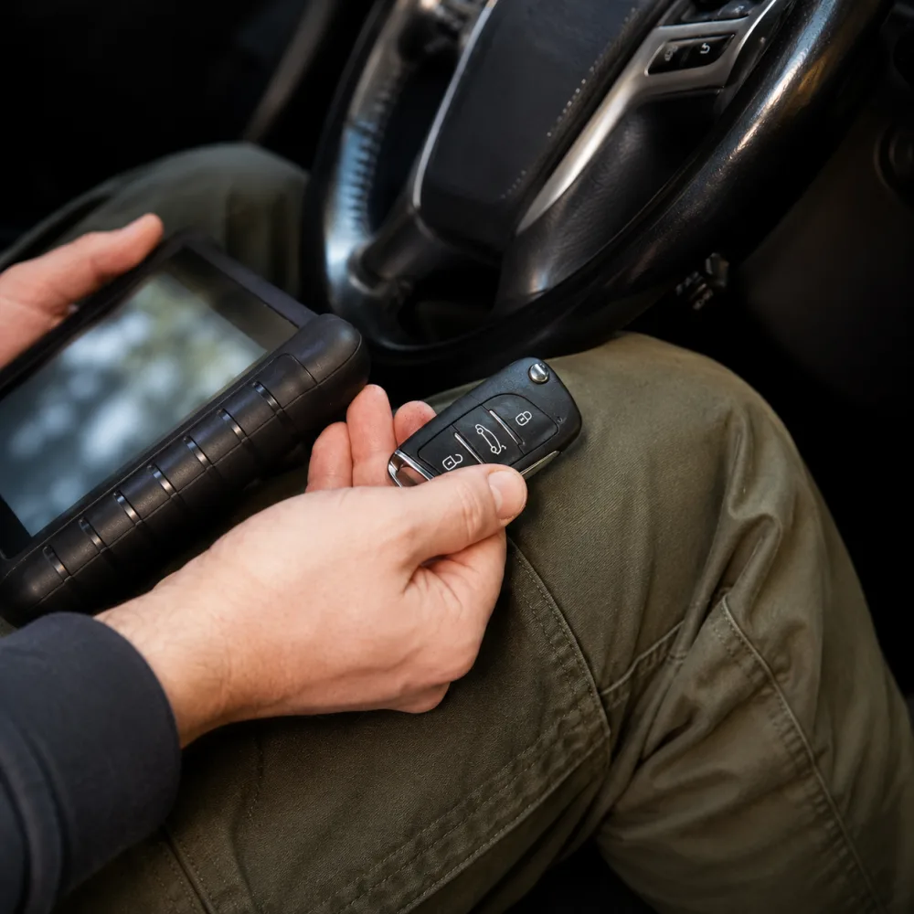 Photo: technician cutting a car key on site in Atlanta