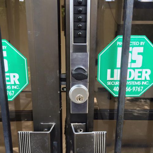 Kaba Simplex commercial keypad lock installed on narrow-stile aluminum door at Brookhaven Police Department