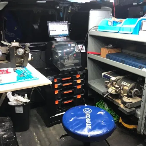 Inside of J&M Locksmith van showing key cutting machines, lock inventory, and professional locksmith equipment